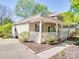 Single-story home with a inviting front porch, neutral exterior paint, and beautifully landscaped yard at 215 6Th St, Belmont, NC 28012
