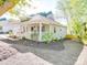 Single-story home with a inviting front porch, manicured landscaping, and neutral exterior paint at 215 6Th St, Belmont, NC 28012