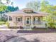 Charming single-story home with inviting front porch, manicured landscaping, and neutral exterior paint at 215 6Th St, Belmont, NC 28012