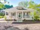 Charming single-story home with inviting front porch, manicured landscaping, and neutral exterior paint at 215 6Th St, Belmont, NC 28012