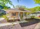 Charming single-story home with inviting front porch, manicured landscaping, and neutral exterior paint at 215 6Th St, Belmont, NC 28012