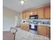 Well-maintained kitchen featuring wood cabinets, stainless appliances, and ample counter space at 215 6Th St, Belmont, NC 28012