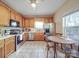 Bright kitchen with wooden cabinetry, stainless steel appliances, and a view of the backyard at 215 6Th St, Belmont, NC 28012