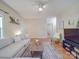 Comfortable living room showcasing a sectional sofa, woven coffee table, and hardwood floors at 215 6Th St, Belmont, NC 28012