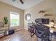 Home office with hardwood floors, large window, desk and built in shelving at 215 6Th St, Belmont, NC 28012