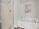 Bright bathroom with a glass-enclosed shower and relaxing soaking tub at 2624 St Helena Ct, Fort Mill, SC 29715