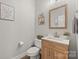 Cozy half-bath features a wooden vanity with white countertop and stylish decor at 2624 St Helena Ct, Fort Mill, SC 29715