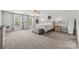 Bright primary bedroom boasts carpet, a ceiling fan, and ample natural light from large windows at 2624 St Helena Ct, Fort Mill, SC 29715