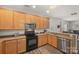 Functional kitchen featuring granite countertops, stainless steel dishwasher, and breakfast bar at 2624 St Helena Ct, Fort Mill, SC 29715