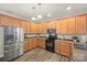 Well-lit kitchen features stainless steel appliances, granite countertops, and ample cabinet space at 2624 St Helena Ct, Fort Mill, SC 29715