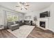 Cozy living room with gray sectional sofa, fireplace, and natural light at 2624 St Helena Ct, Fort Mill, SC 29715