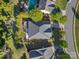 An aerial view of a home showcasing the roof, pool, landscaping, and surrounding neighborhood at 281 Loch Stone St, Fort Mill, SC 29715