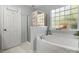 This bathroom has a separate shower and tub with a window providing natural light at 281 Loch Stone St, Fort Mill, SC 29715