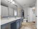 Bathroom with vanity, blue cabinets, large mirror, tile flooring, and a toilet at 281 Loch Stone St, Fort Mill, SC 29715