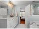 A bathroom features a double vanity and soaking tub, with a view to the main bedroom at 281 Loch Stone St, Fort Mill, SC 29715