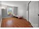 Bright bedroom featuring wood floors, a cozy window seat, and neutral wall color at 281 Loch Stone St, Fort Mill, SC 29715