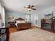Comfortable bedroom boasts a fireplace, decorative rug on hardwood floors, and a ceiling fan at 281 Loch Stone St, Fort Mill, SC 29715