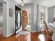 Inviting foyer with hardwood floors and chandelier, offering a glimpse into a bright, open dining space at 281 Loch Stone St, Fort Mill, SC 29715
