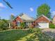 Charming brick home with a well-manicured lawn and landscaping, complemented by a two-car garage at 281 Loch Stone St, Fort Mill, SC 29715