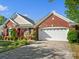 Beautiful home showcasing manicured landscaping, a two-car garage, and appealing architecture at 281 Loch Stone St, Fort Mill, SC 29715