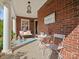 Inviting front porch with brick accents, adorned with seating and charming decor for relaxation at 281 Loch Stone St, Fort Mill, SC 29715