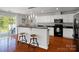 Modern kitchen with black appliances, granite countertops, bar seating, and access to outdoor patio at 281 Loch Stone St, Fort Mill, SC 29715