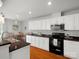 Well-lit kitchen featuring granite countertops, white cabinetry, black appliances, and a breakfast nook at 281 Loch Stone St, Fort Mill, SC 29715