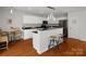 Modern kitchen with white cabinets, black appliances, breakfast bar, and eat in breakfast nook at 281 Loch Stone St, Fort Mill, SC 29715