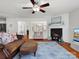 Inviting living room featuring a fireplace, hardwood floors, and an open view to the kitchen at 281 Loch Stone St, Fort Mill, SC 29715