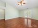 A spacious bedroom features a ceiling fan and french doors to the outside at 3022 Willamette Valley Dr, Charlotte, NC 28215
