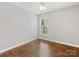 This bedroom features hardwood floors, neutral walls, and a single window at 3022 Willamette Valley Dr, Charlotte, NC 28215