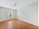 This bedroom features hardwood floors, a window, and neutral wall color at 3022 Willamette Valley Dr, Charlotte, NC 28215