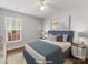 Bright staged bedroom with a large window, modern decor, and neutral tones at 3022 Willamette Valley Dr, Charlotte, NC 28215