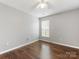 This bedroom features hardwood floors, a window, and neutral wall color at 3022 Willamette Valley Dr, Charlotte, NC 28215