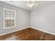 This bedroom features hardwood floors, neutral walls, and a single window at 3022 Willamette Valley Dr, Charlotte, NC 28215