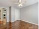 This bedroom features hardwood floors, neutral walls, and a door leading to the hallway at 3022 Willamette Valley Dr, Charlotte, NC 28215