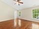 A bright bedroom featuring a ceiling fan and hardwood floors throughout at 3022 Willamette Valley Dr, Charlotte, NC 28215