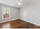 This bedroom features hardwood floors, a window, and neutral wall color at 3022 Willamette Valley Dr, Charlotte, NC 28215