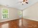 A bright bedroom with hardwood floors, a ceiling fan and a window at 3022 Willamette Valley Dr, Charlotte, NC 28215