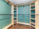 This custom closet includes wood shelving, and wood floors at 3022 Willamette Valley Dr, Charlotte, NC 28215
