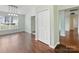 Spacious dining room with hardwood flooring, modern light fixture, and a view into the kitchen and other rooms at 3022 Willamette Valley Dr, Charlotte, NC 28215