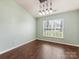 Bright dining area features modern lighting, window view, and rich wood flooring at 3022 Willamette Valley Dr, Charlotte, NC 28215