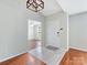 Bright foyer with neutral walls, tile and wood flooring, decorative lighting, and a view into the dining area at 3022 Willamette Valley Dr, Charlotte, NC 28215