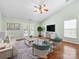 Comfortable living room with hardwood floors, ceiling fan, and access to the outdoors through french doors at 3022 Willamette Valley Dr, Charlotte, NC 28215