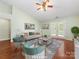 Well lit living room boasts a ceiling fan, french doors, and hardwood floors at 3022 Willamette Valley Dr, Charlotte, NC 28215