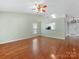 Open-concept living area features wood floors and a ceiling fan at 3022 Willamette Valley Dr, Charlotte, NC 28215