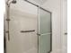 This bathroom includes a glass enclosed shower with a showerhead and handle at 3022 Willamette Valley Dr, Charlotte, NC 28215