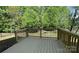 View of a wooden back deck overlooking the backyard with beautiful trees at 3030 Collin House Dr, Fort Mill, SC 29715