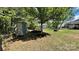 View of the backyard with an outdoor storage shed, firepit, and wrought iron fence at 3030 Collin House Dr, Fort Mill, SC 29715
