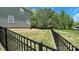 View of backyard showing the black wrought iron fence and mature trees at 3030 Collin House Dr, Fort Mill, SC 29715